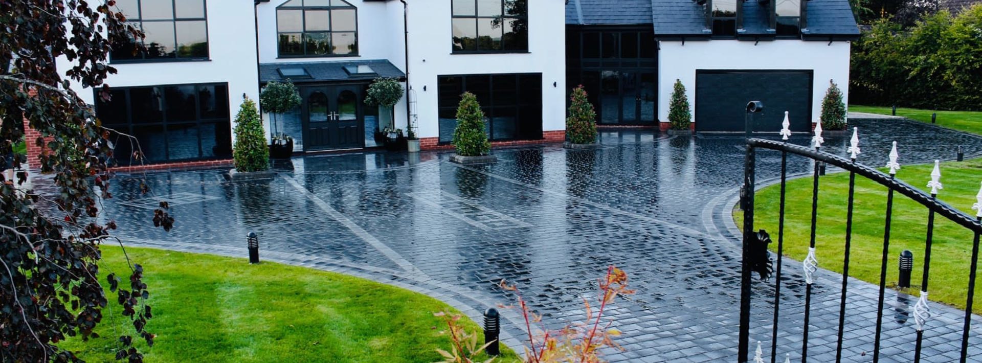 Marshalls Drivesys Riven paving laid on the driveway of a modern white house 