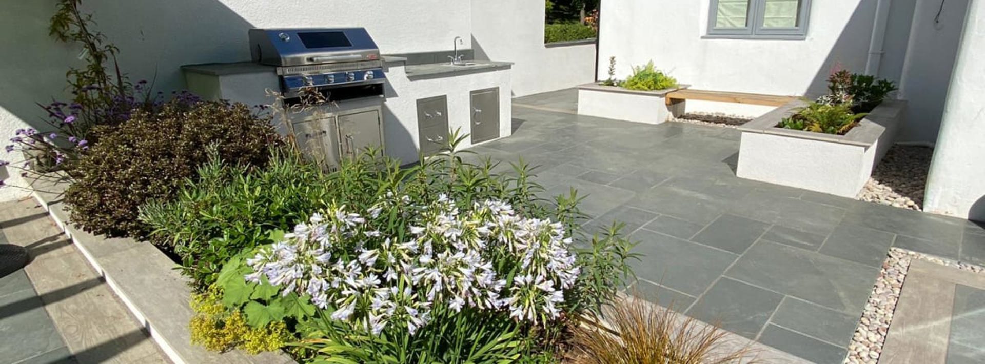 A modern garden with Marshalls Casarta slate paving and an outside kitchen