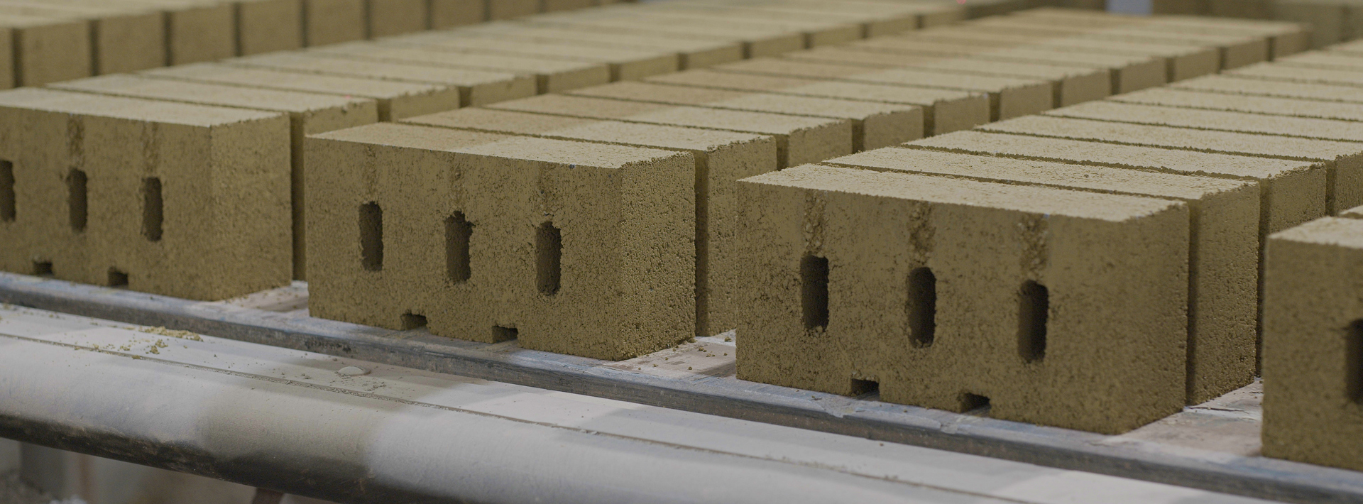 Carbon cure bricks lined up next to each other on a flat surface