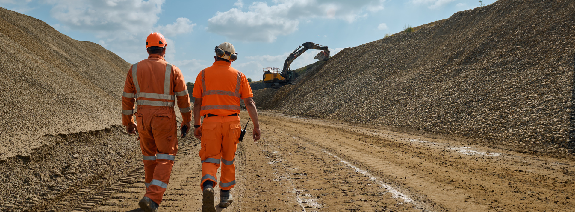 Aggregates staff in high vis workwear walking on site