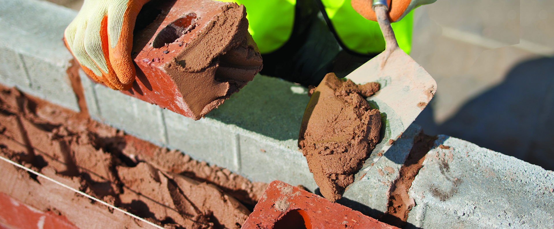 Ready to use mortar being placed onto a brick