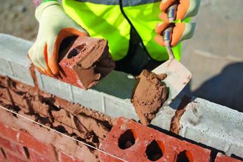 Ready to use mortar being placed onto a brick