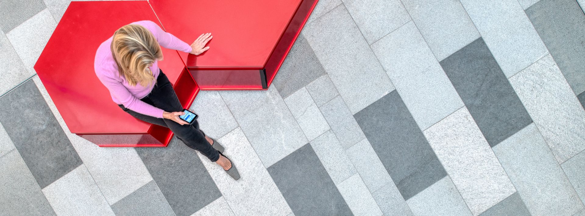 Women sat on a red bench at Watford shopping centre