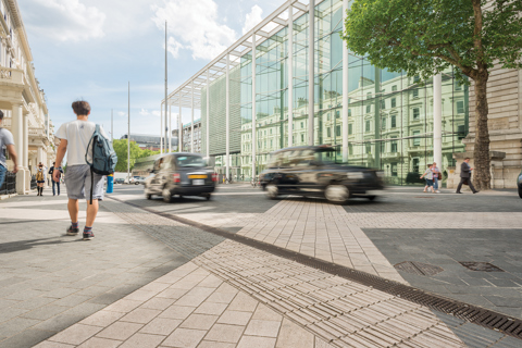 Members of the public walking down a busy street in London