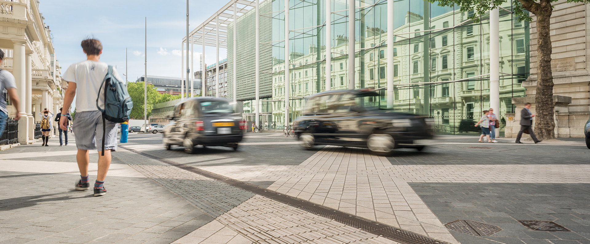 Members of the public walking down a busy street in London