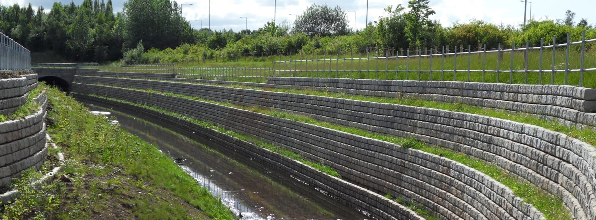 Marshalls Redi Rock flood walls alongside a stream